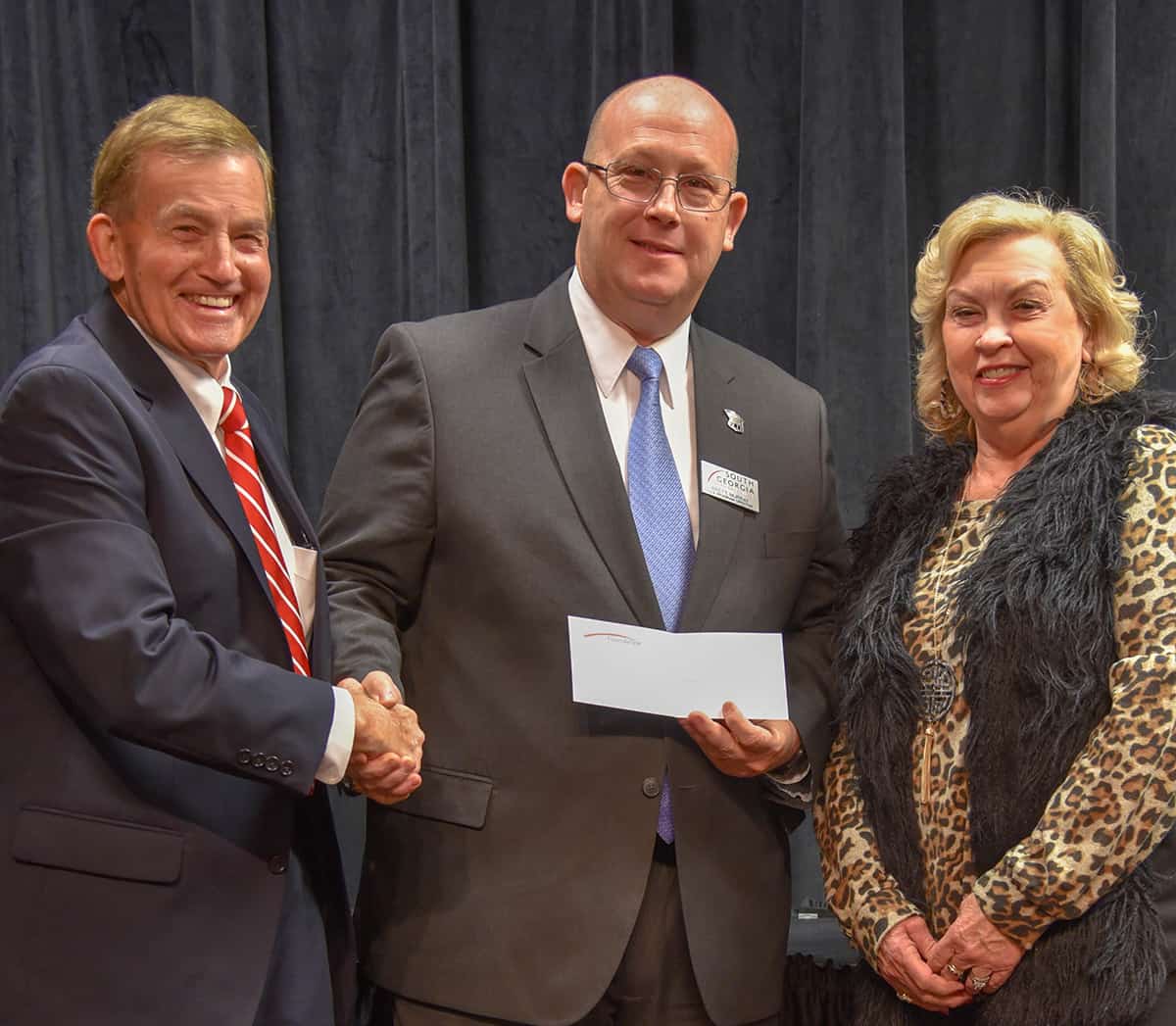 South Georgia Technical College President Emeritus Sparky Reeves (l) and Allene (r), are shown above presenting a check to SGTC 2019 Instructor of the Year Brett Murray (c).