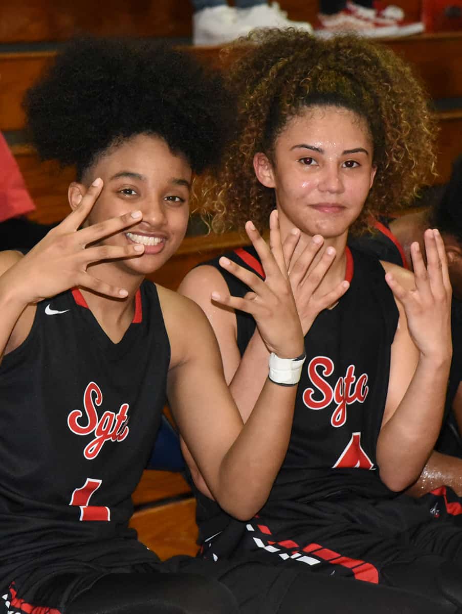 Alyssa Nieves, 4, (right) is shown above with her teammate Ricka Jackson, 1, after the two learned that Nieves had scored over 40 points in the game against Andrew College.