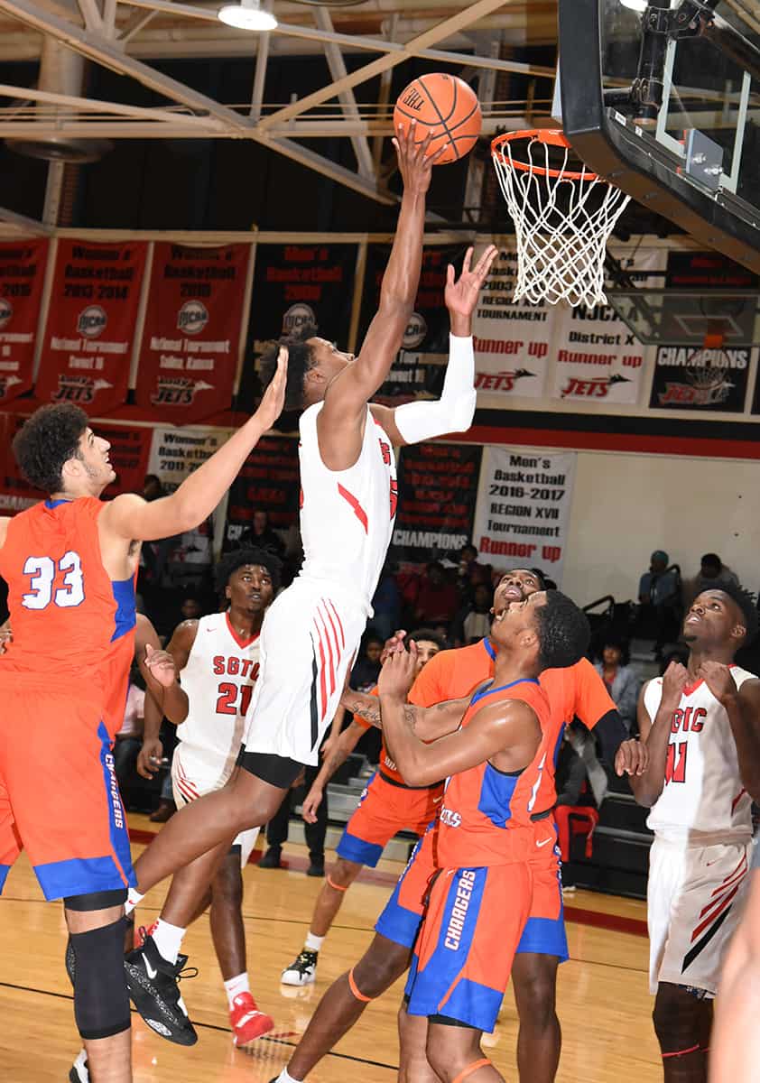 : Justin Johnson, 5, is shown above taking it to the basket against Georgia Highlands.