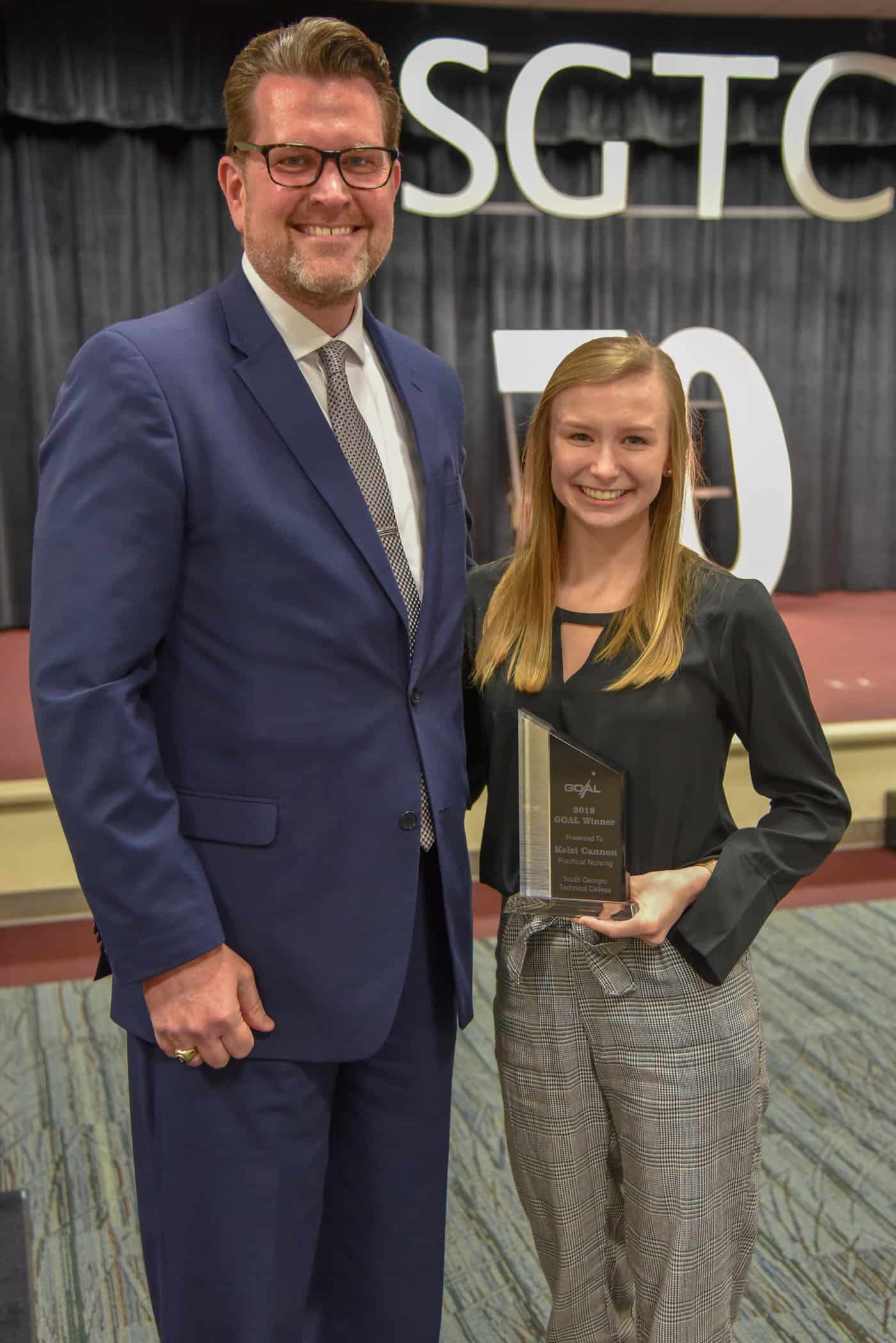 South Georgia Technical College’s 2019 GOAL Winner, Kelsi Cannon (right), accepts her award from SGTC president Dr. John Watford. Cannon will represent the college at the regional and state level in search of the Student of the Year title.