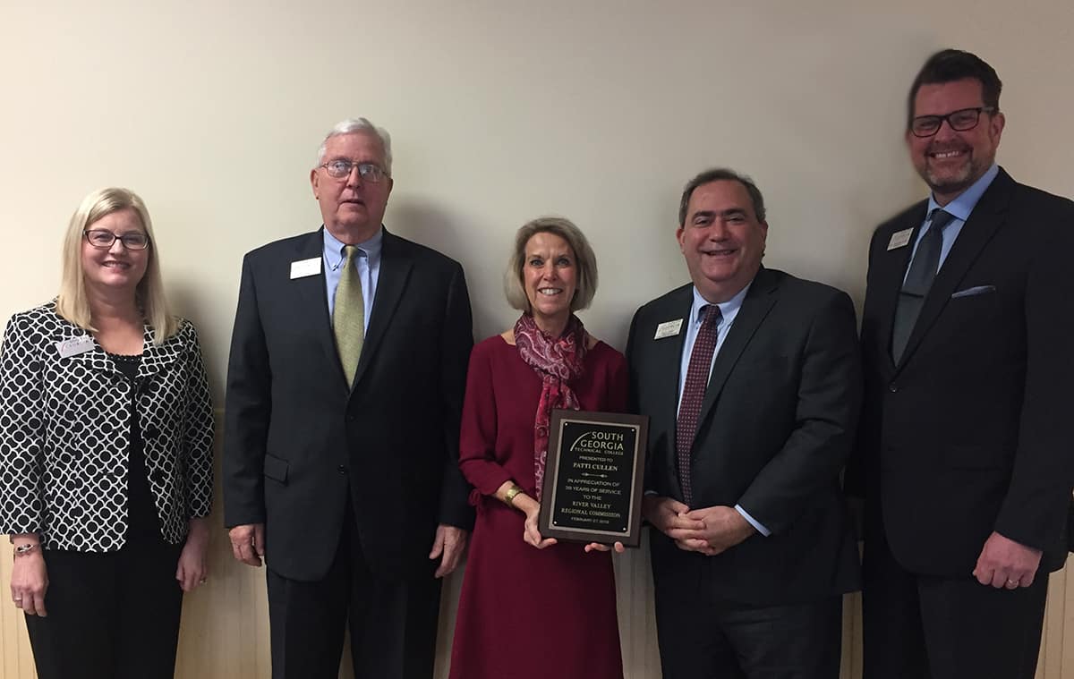 RVRC Executive Director Patti Cullen is shown above (center) accepting a plaque from South Georgia Technical College officials in appreciation of her 38 years of service to the River Valley Regional Commission. Shown (l to r) with Cullen are SGTC Director of Business and Industry Services Michelle McGowan, SGTC Vice President of Economic Development Wally Summers, SGTC Director of Business and Industry Services Paul Farr and SGTC President Dr. John Watford.