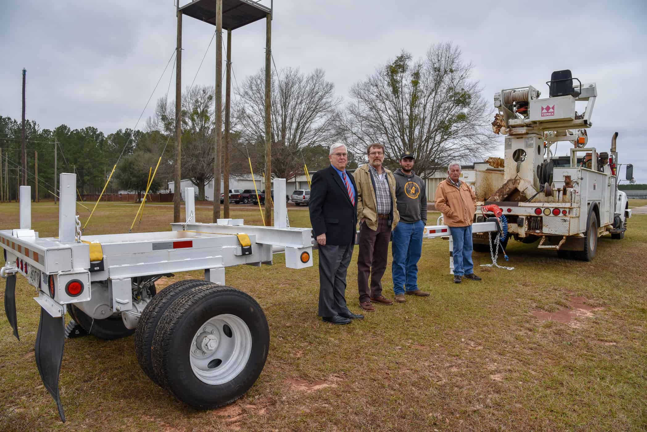 The pole trailer donated to the South Georgia Technical College Foundation for the Electrical Lineworker Program by Colquitt EMC and painted and refurbished by Diverse Power is shown above. South Georgia Technical College Vice President of Economic Development Wally Summers is shown above with Bubba Allen of Diverse Power, Tyler Flowers, a former SGTC lineworker student who now works for Diverse Power, along with Dewey Turner, SGTC Lineworker instructor.