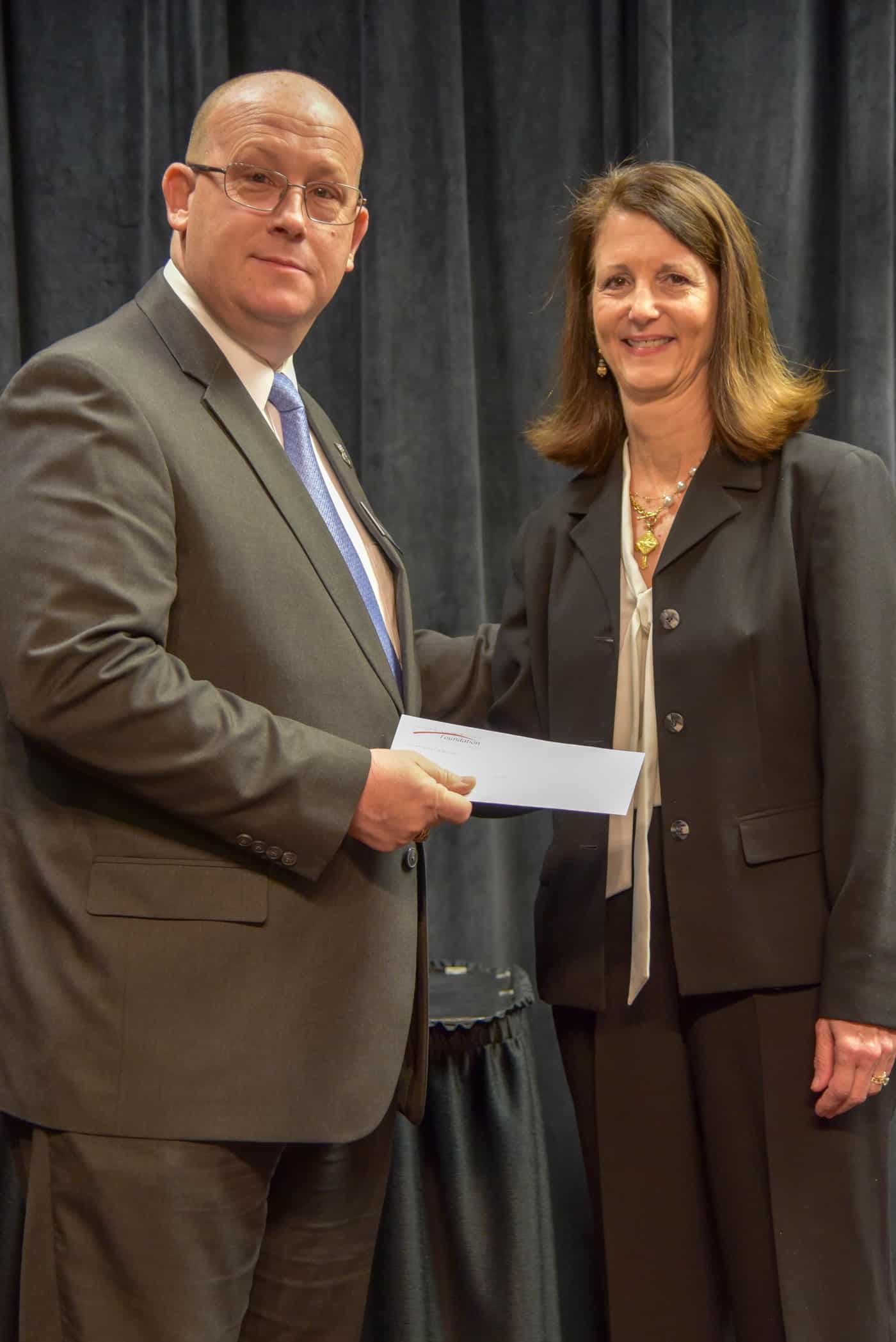 Synovus’ Tami Duke is shown above (right) presenting Brett Murray with a donation from Synovus for being selected as the South Georgia Technical College 2019 Instructor of the Year.