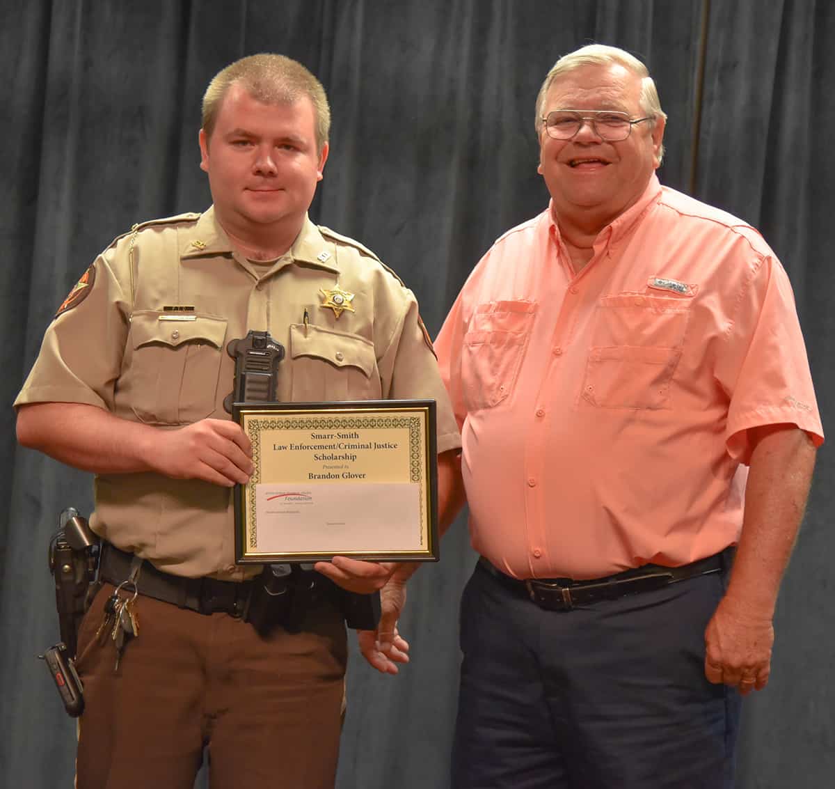 Paul Johnson (right) is shown above recognizing Brandon Glover (left) of the Sumter County Sheriff’s Office with a Smarr-Smith Criminal Justice Scholarship.