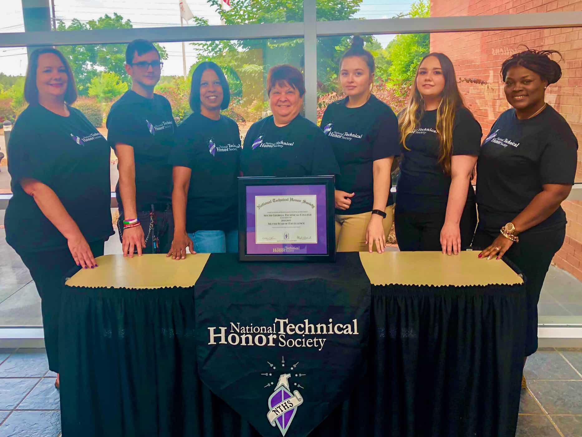 National Technical Honor Society members and advisors stand with their Silver Star of Excellence award, given for their outstanding community service during the 2018-2019 academic year. Left to right: Kari Bodrey, NTHS advisor; Christopher Mathews, NTHS President; Nicole Embry, NTHS Vice President; Evelyn Castleberry, NTHS member; Kennedy Allen, NTHS member; Samantha Campbell, NTHS Secretary; Katrice Taylor, NTHS advisor.