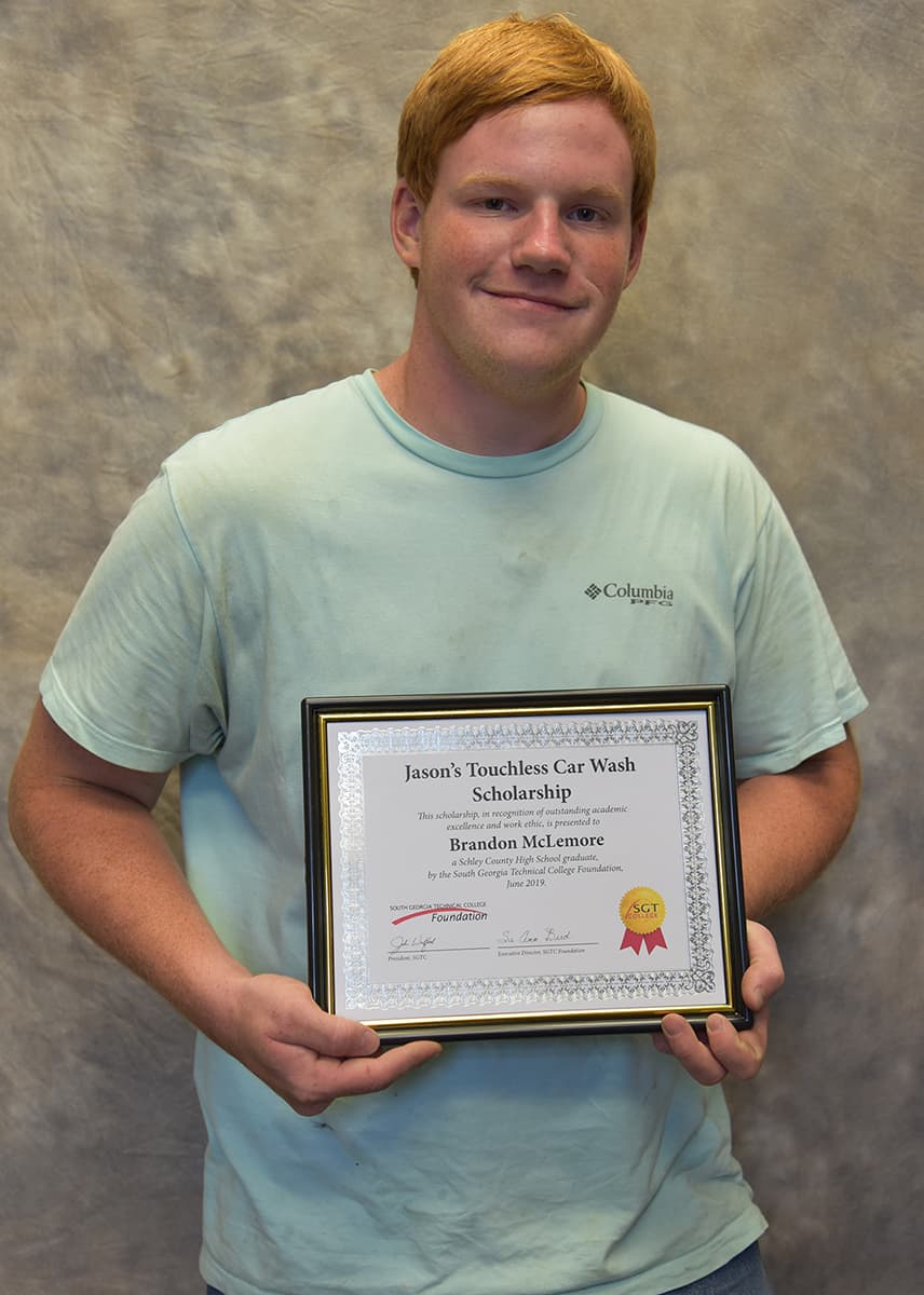 Shown above is South Georgia Technical College Motorsports Vehicle Technology student Brandon McLemore of Americus with his scholarship certificate from Jason’s Car Wash and J & J’s Oil Change.