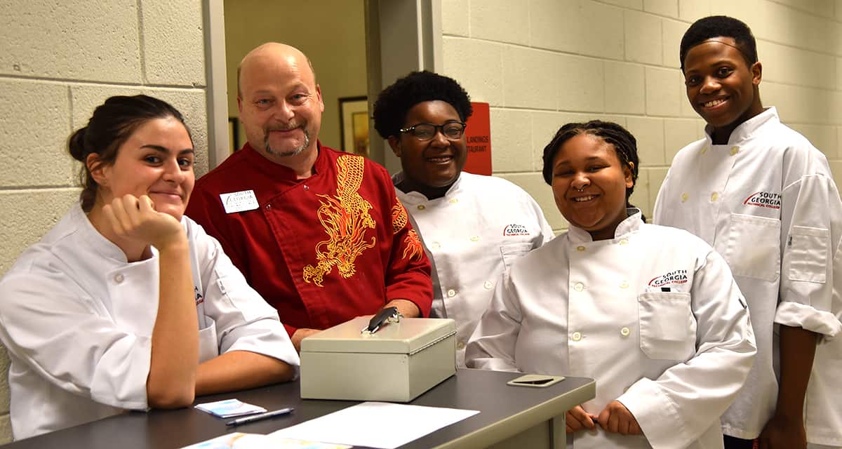 Chef “Ricky” Ludwig Watzlowick is shown above with some of the South Georgia Technical College culinary arts students who helped prepare the Jamaican cuisine presented as part of the “pop-up” restaurant project.