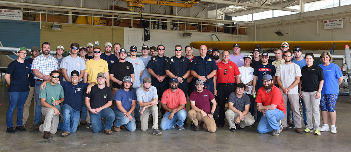 Americus Fire Department officials volunteer to cook out for the South Georgia Technical College Aviation students at the end of Summer Semester. Shown above are the firemen with their “We are Impacting Success @ SGTC” t-shirts and then they are shown with members of the SGTC aviation department and their students.