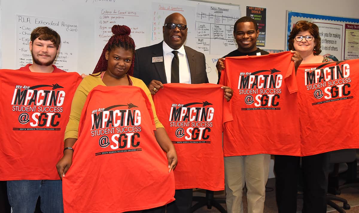 SGTC Economic Development Specialist Al Harris is shown above (center) with Tracey Israel, SGTC Adult Education Transition Specialist (right) and three of the four Adult Education students who passed their OSHA-10 certification training. The students shown are Ryan Lamar, Alexis White and Alex Hale. Not shown is Darrius Daniels. The students were presented with Impacting success t-shirts from South Georgia Technical College for their successful completion of the OSHA-10 training.