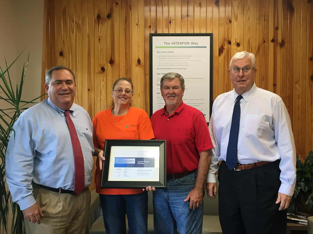 South Georgia Technical College Director of Business and Industry Services Paul Farr and South Georgia Technical College Vice President of Economic Development Wally Summers (right) are shown above presenting Rhonda Holbrook and Eddie Riles of Interfor Preston Division with a special plaque signed by Governor Brian Kemp listing them as a Small Manufacturer of the Year nominee in Georgia for 2019.