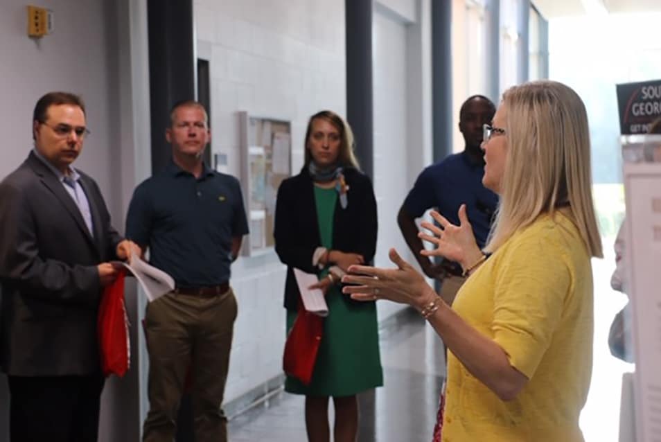 South Georgia Technical College Business and Industry Director Michele McGowan is shown above (r) touring the group through the South Georgia Technical College Crisp County Center building and showing them how SGTC and the Cordele-Crisp County IDC work together to help bring economic prospects to the area.