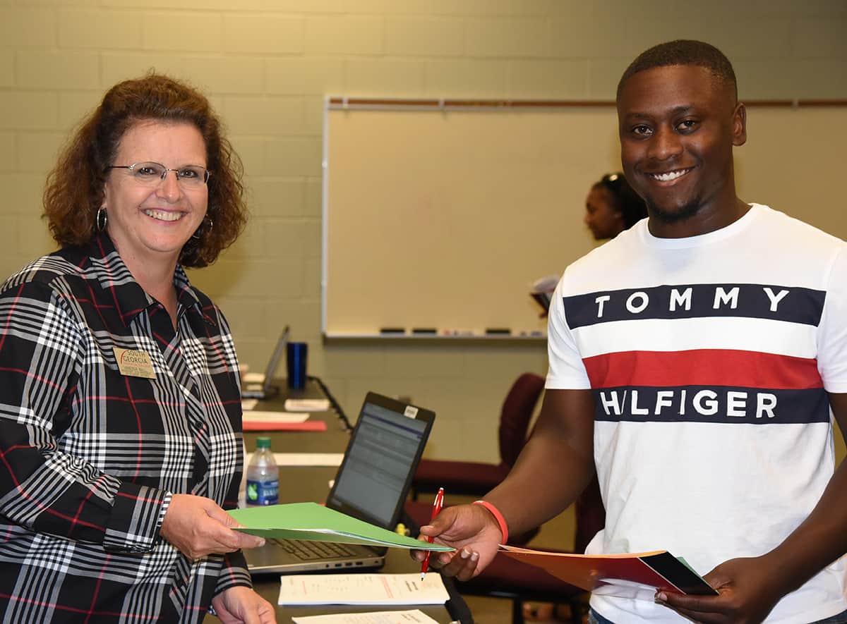 South Georgia Technical College Assistant Vice President of Student Affairs is shown above with a new student registering for Fall Semester. She is also taking his on-campus housing application.