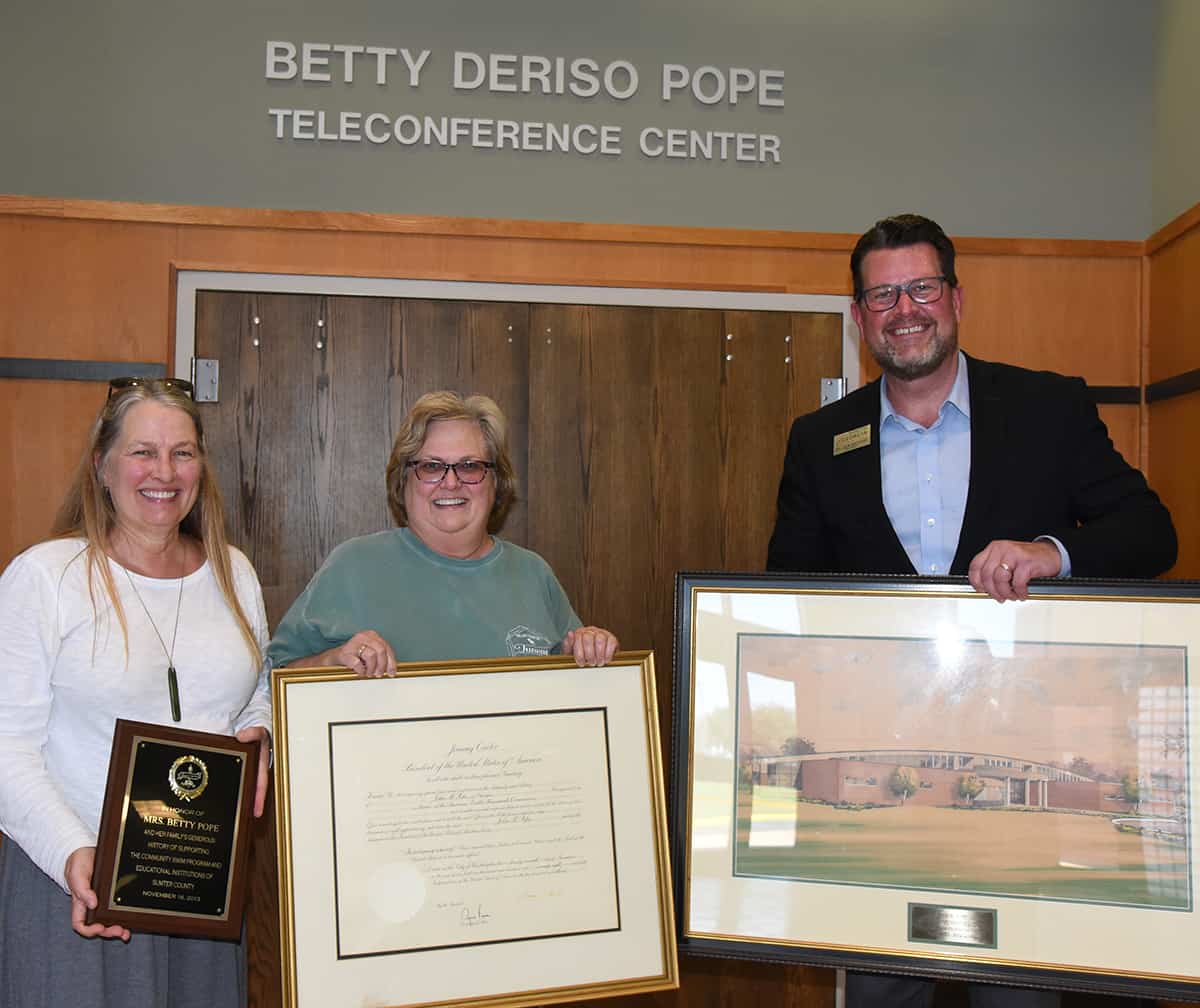 Kelli Kindred Phillips and Kerri Kindred Post are shown above with South Georgia Technical College President Dr. John Watford displaying some of the items they presented to South Georgia Technical College in memory of their mother, Elizabeth “Betty” Deriso Pope.