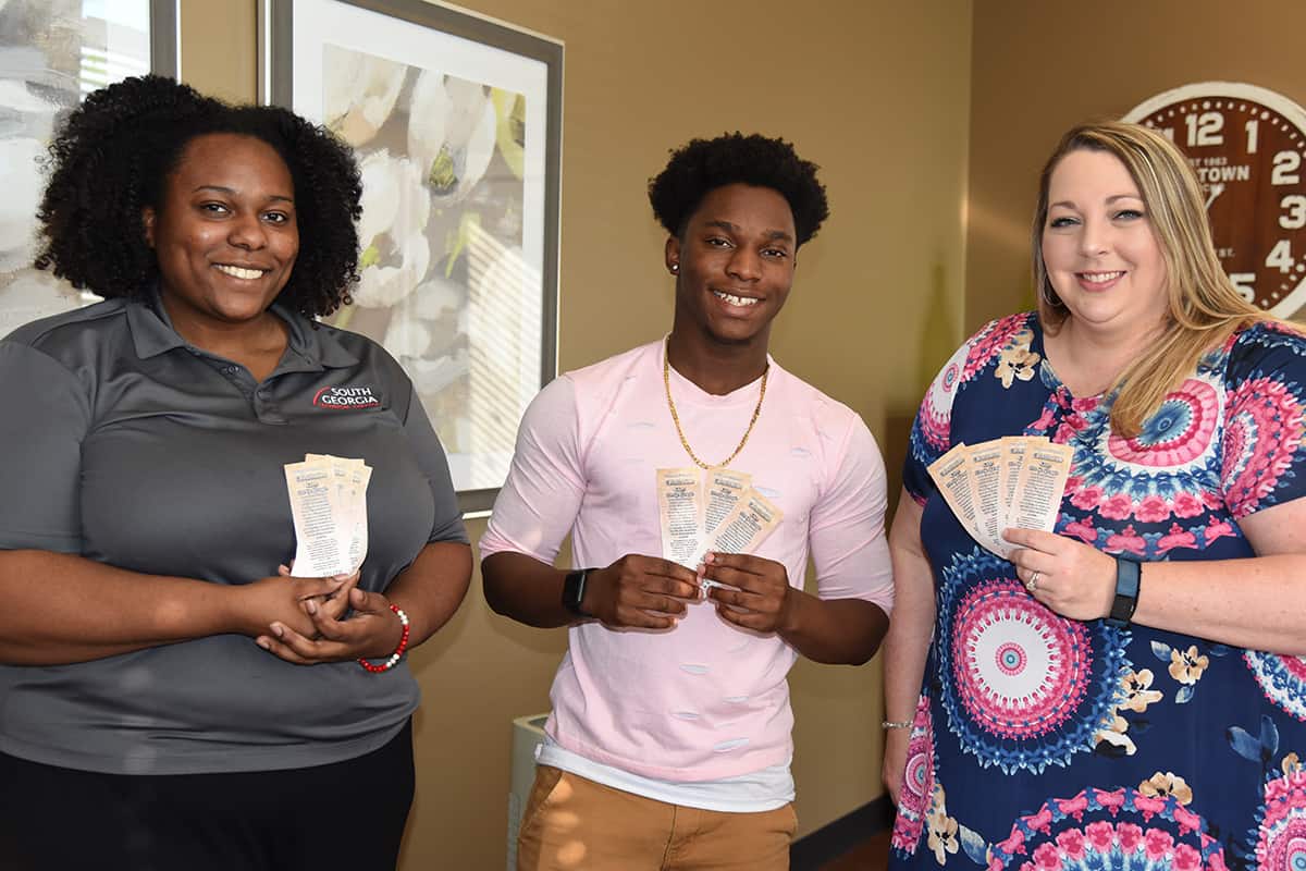 SGTC Financial Aid Director Kelly Everett (r) is shown above with SGTC accounting student Adanous Brown (C) and SGTC Financial Aid Specialist Kierra Sparks (l) with a handful of the bookmarks that were printed up for the faculty, staff, and students in observance of Constitution Day recently.