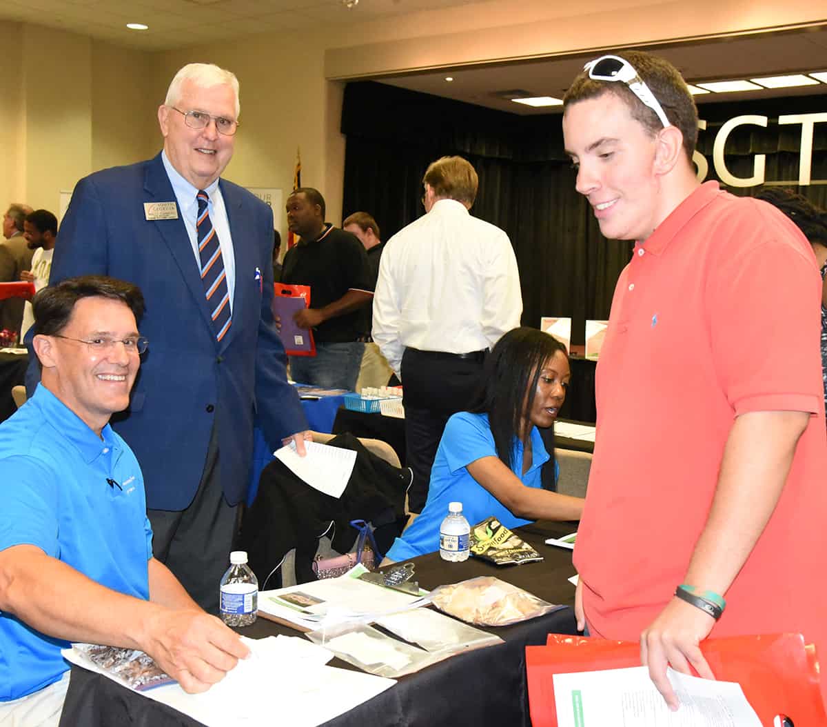 Wally Summers (standing, left), Vice President of Economic Development at South Georgia Technical College, with representatives from International Paper at the Job Fair