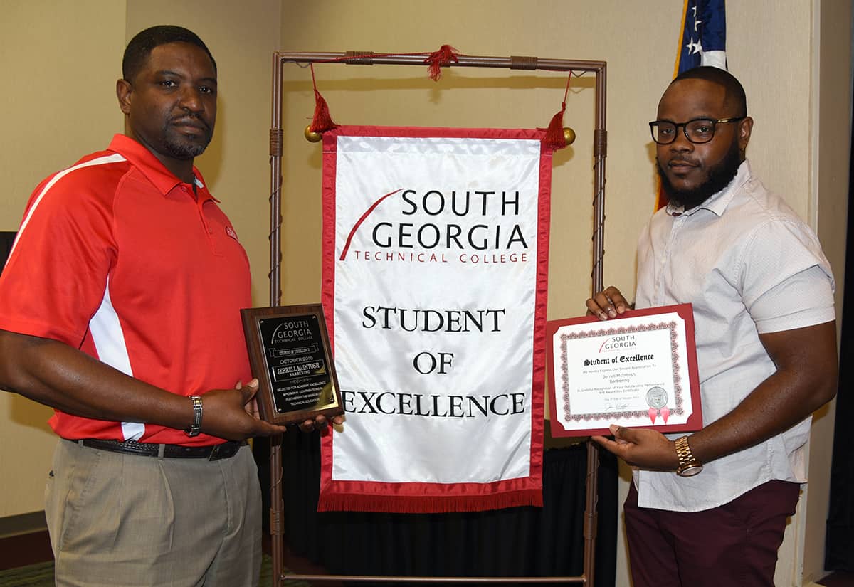 SGTC Cordele Student of Excellence Jerrell McIntosh (right) is pictured with barbering instructor Xavier Jackson.