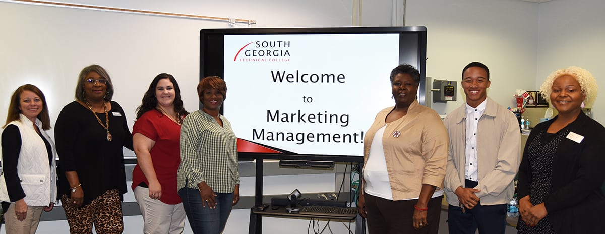 South Georgia Technical College Marketing Management Instructor Mary Cross (right center) is shown above with members of her Advisory Committee in the SGTC Americus campus Marketing Management classroom. Shown (l to r) are SGTC Grant Coordinator Nancy Fitzgerald, Harriet Glover of Belk, SGTC Administrative Assistant for Academic Affairs April Hilliard, Andrea Tatum, Mary Kay Consultant, SGTC Marketing Management Instructor Mary Cross, Marketing student Xavier Winfield, and SGTC Academic Dean Dr. Andrea Oates.