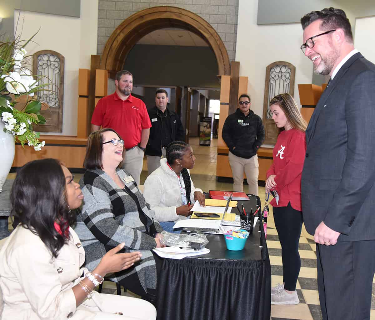 South Georgia Technical College President Dr. John Watford (standing right) is shown talking with South Georgia Technical College employees and students during the recent Spring Semester registration. SGTC will hold another Spring Semester registration on January 7th.
