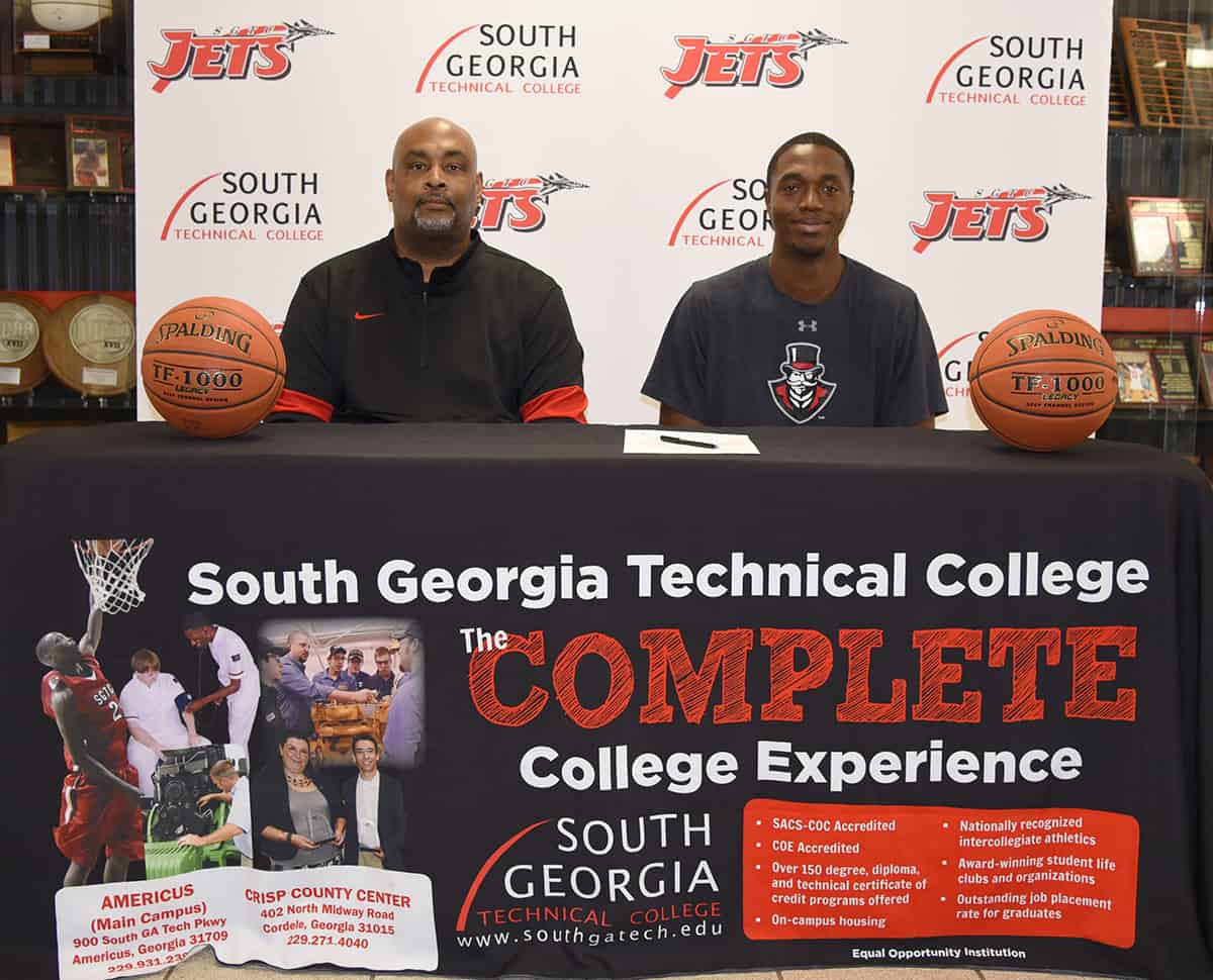 SGTC Jets Head Coach Travis Garrett (left) with Jets player Merdy Bata as Bata prepares to sign a letter of intent to play at Austin Peay State University.
