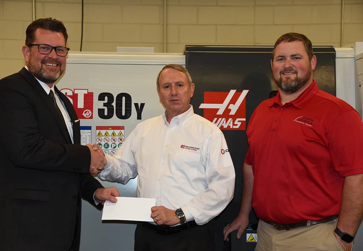 South Georgia Technical College President Dr. John Watford is shown above accepting a check from David Aycock with Gene Haas for the SGTC Precision Machining and Manufacturing Program. Chad Brown, SGTC Precision Machining and Manufacturing Instructor is also shown.