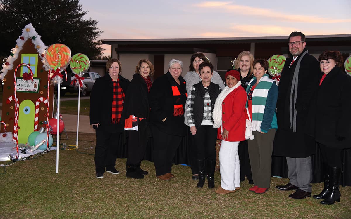 SGTC President Dr. John Watford and his wife, Barbara are shown above with members of the South Georgia Technical College Adult Education Division in front of their lighted display.