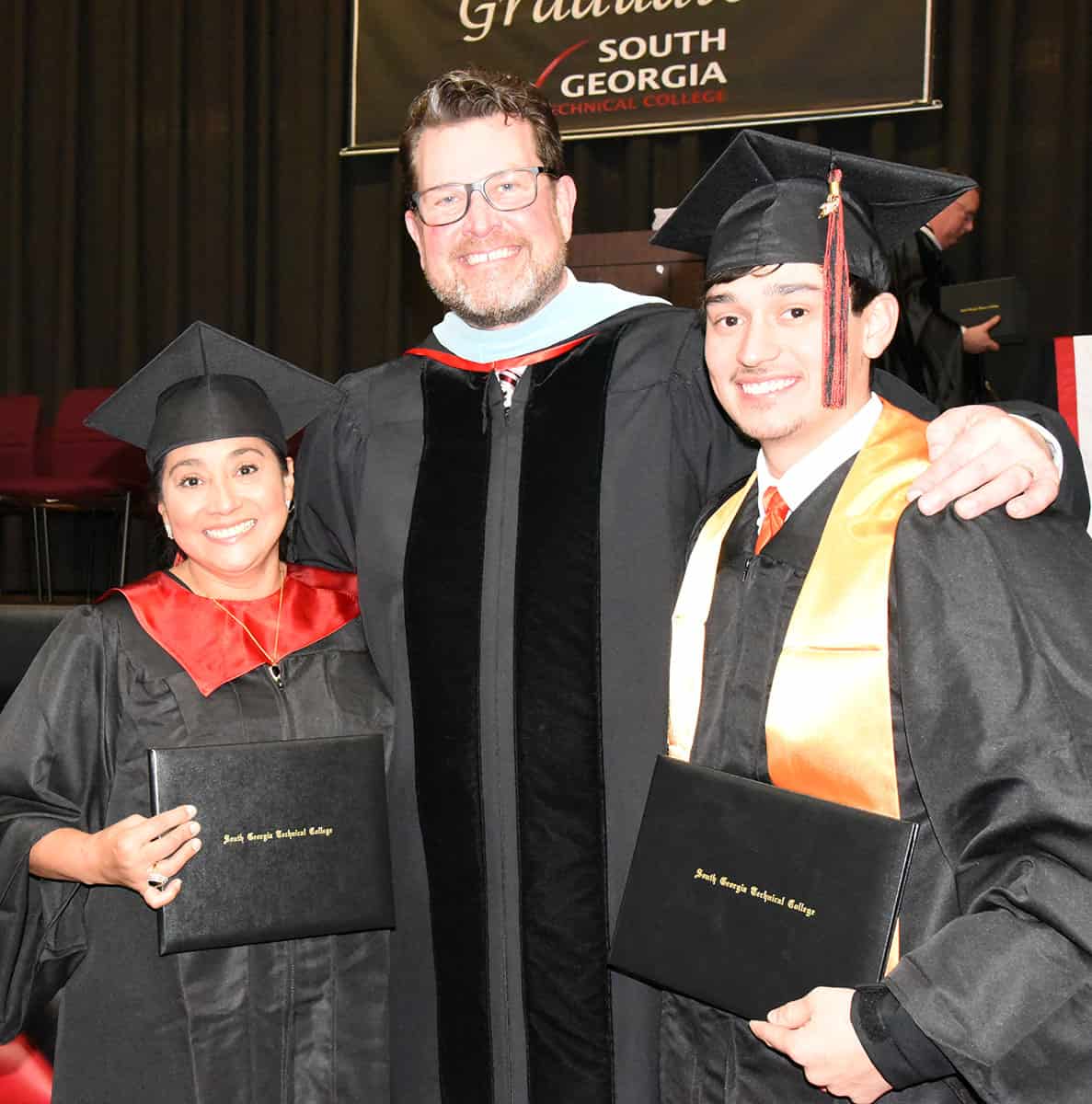 South Georgia Technical College President Dr. John Watford is shown above with SGTC Adult Education employee Kenia Wills who earned her Computer Support Specialist Associate Degree and her son, Kenneth Willis who was a Presidential Honor Graduate from the Welding and Joining Technology program.