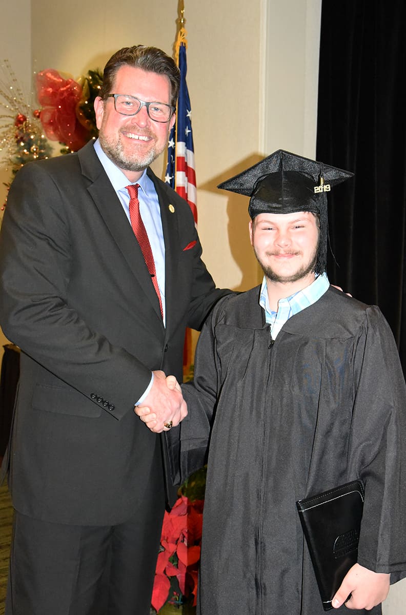South Georgia Technical College President Dr. John Watford is shown above with Fall 2019 Adult Education graduate Alexander Hale.