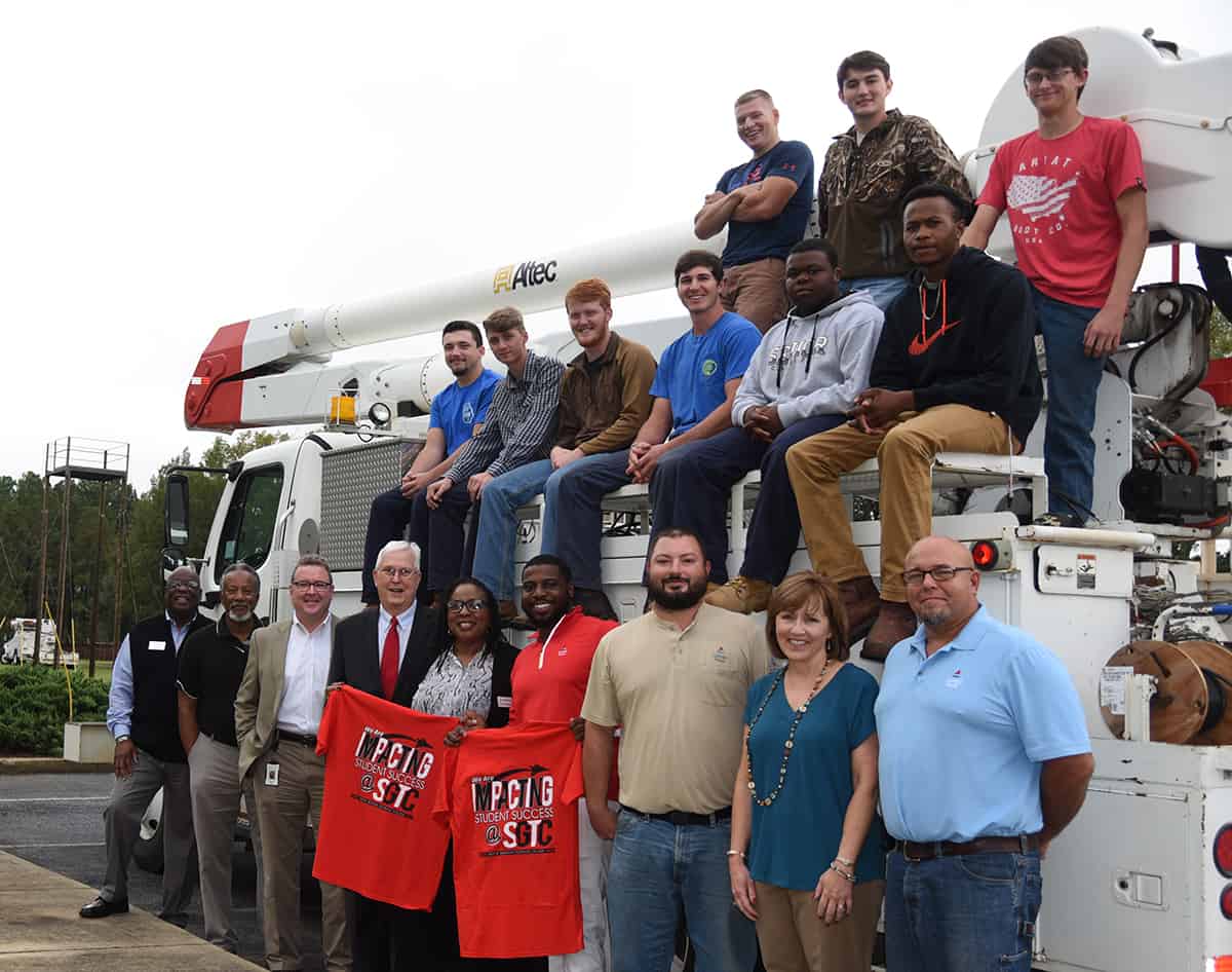 Georgia Power donated a 2009 Freightliner Bucket Truck to the South Georgia Technical College Foundation recently to be used in the college’s Electrical Lineworker program. Shown above (l to r) in front of the truck are: Al Harris from the SGTC Economic Development Division, SGTC Lineworker Instructor Sidney Johnson, Don Porter from the local Georgia Power division, SGTC Economic Development Vice President Wally Summers, Georgia Power Company Workforce Development Coordinator Marilyn Walker, Kenny Holiday, GPC Talent Acquisitions, Ryan Jenkins, Georgia Power Crew Leader Distribution Line and SGTC Electrical Lineworker graduate, SGTC Economic Development Assistant Tami Blount, and Georgia Power’s Phillip Brooks. Shown seated and standing on the truck are members of the SGTC Electrical Lineworker Fall Semester class.