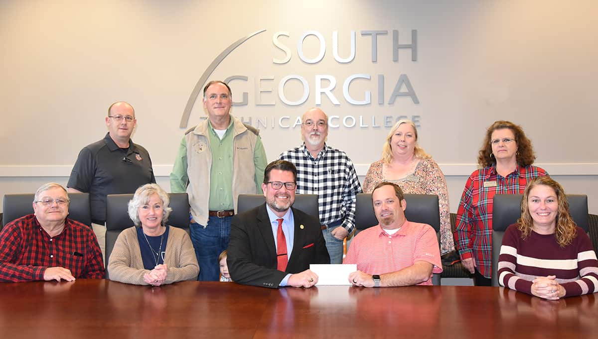 Smarr-Smith Foundation Chairman Blake Dukes (seated right center) is shown above presenting SGTC President Dr. John Watford (seated left center) with a scholarship check from the Smarr - Smith Foundation to add to the endowed scholarship at South Georgia Technical College. Also shown (l to r) seated with Dr. Watford and Blake Dukes are Paul and Sharron Johnson and Jessie Simmons. Standing (l to r) are SGTC Law Enforcement Academy Director Brett Murray, Americus Police Chief Mark Scott, Donnie McCrary, SGTC Criminal Justice Instructor Teresa McCook and SGTC Assistant Vice President of Student Affairs Vanessa Wall.