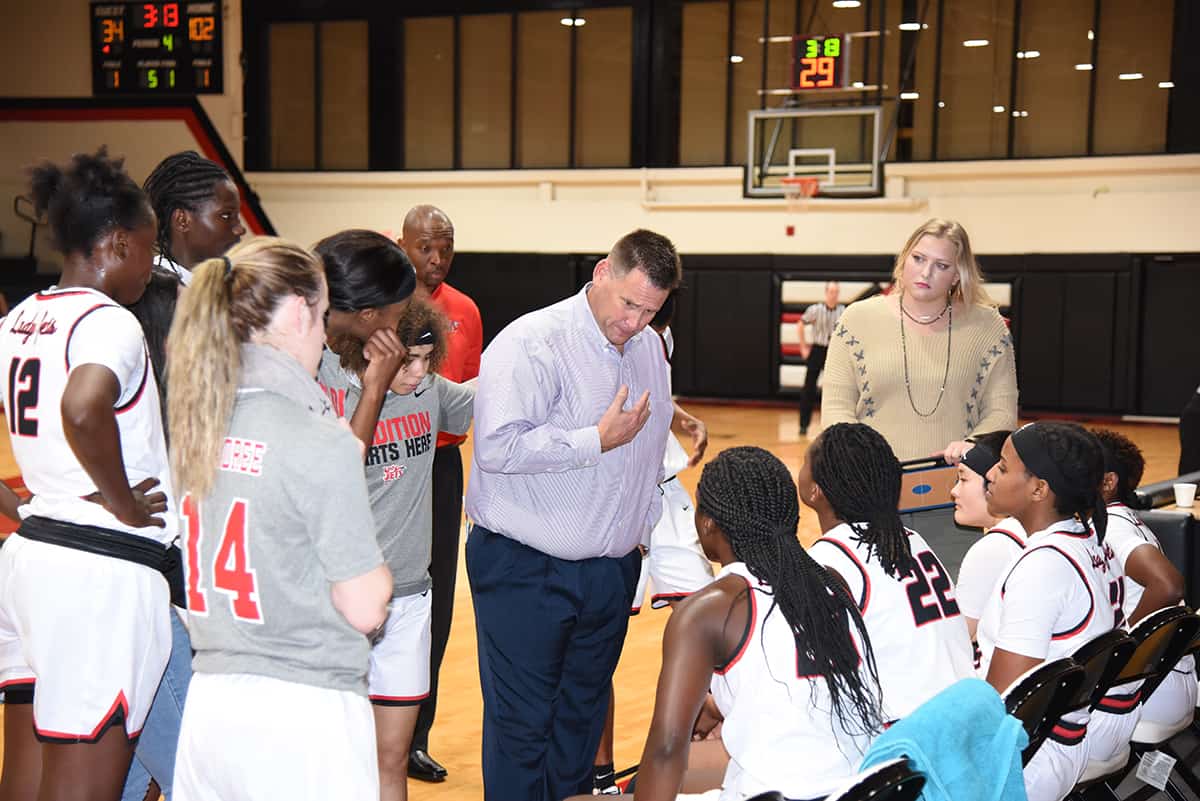Lady Jets head coach James Frey is shown talking with his team during a time-out against Southern Crescent.
