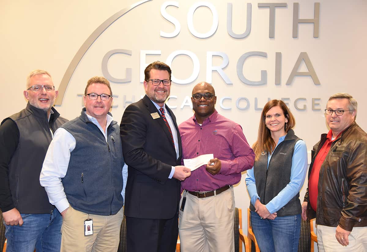 South Georgia Technical College President Dr. John Watford is shown above (center left) thanking Georgia Power Executive Vice President Customer Service and Operations Pedro Cherry (center right). Shown (l to r) are: Georgia Power Human Resources Manager John Hood; Georgia Power Local Manager Don Porter, South Georgia Technical College President Dr. John Watford, Georgia Power’s Pedro Cherry, Assistant to Executive Vice President Customer Service and Operations Rachel Williams and Georgia Power Regional Director Joe Brownlee.