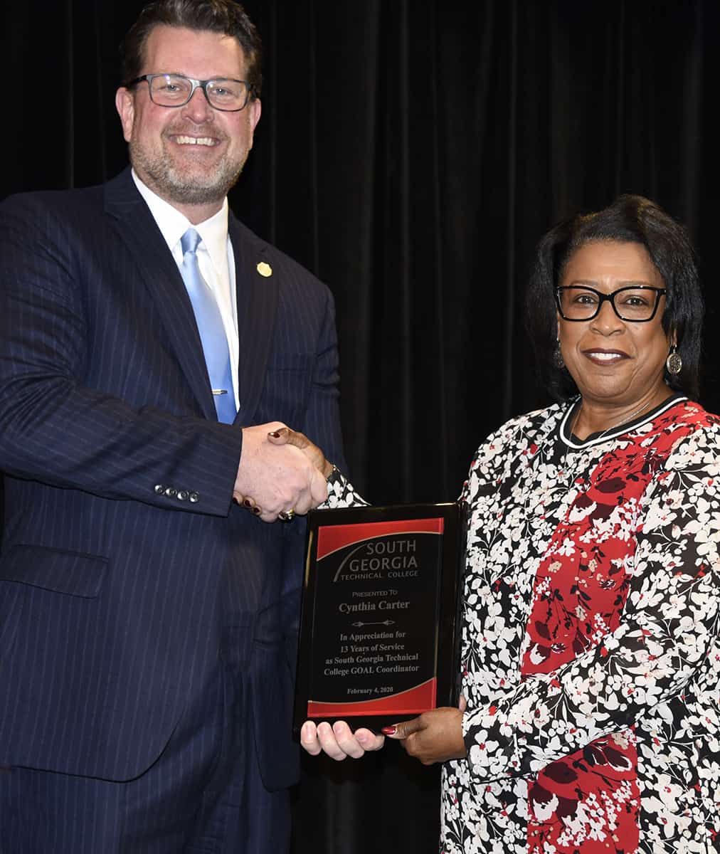 SGTC President Dr. John Watford is shown above (l) presenting former GOAL Coordinator Cynthia Carter with a plaque for her 13 years of service to the SGTC GOAL program.