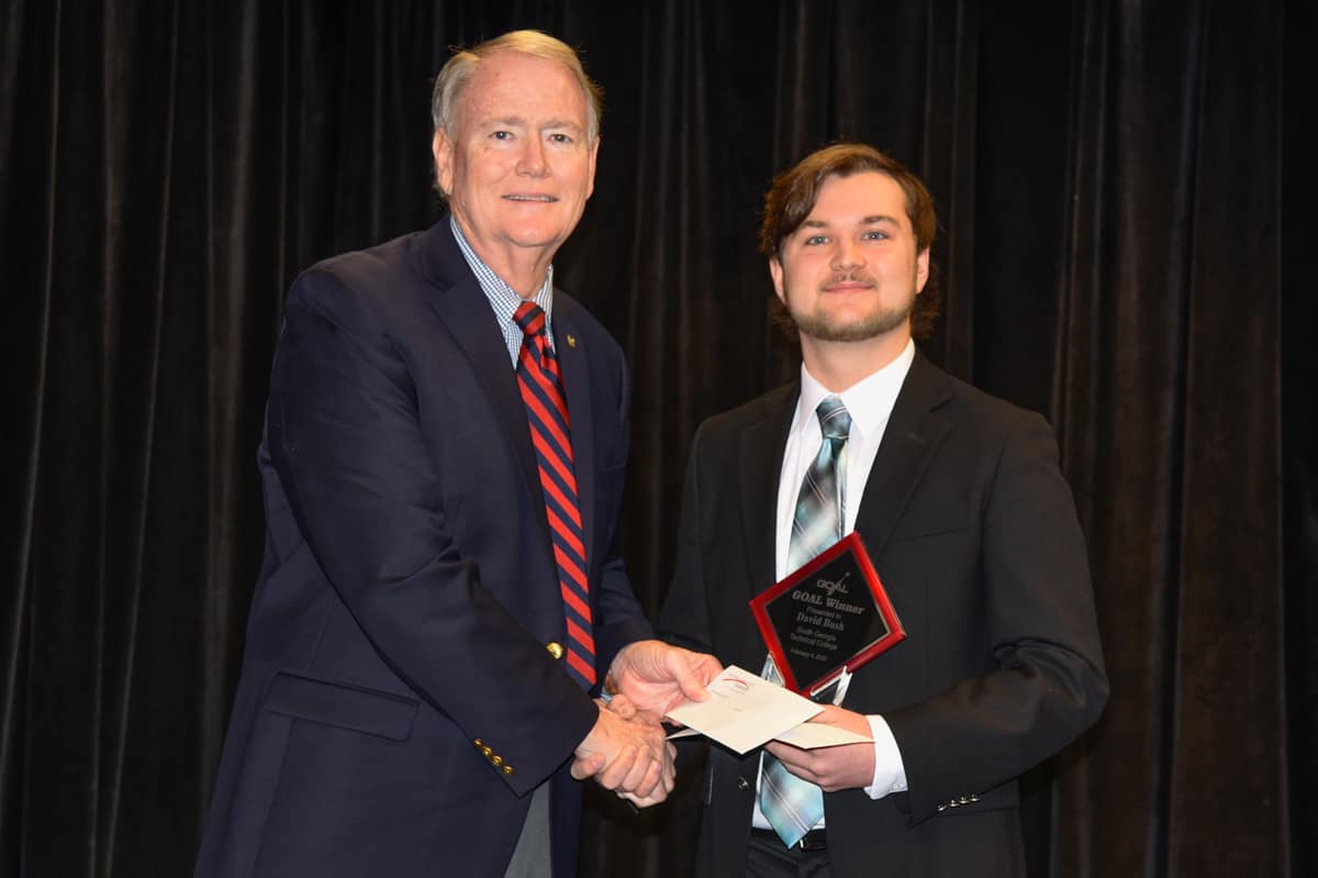 Americus Rotary Club Past President Don Smith (l) is shown above presenting a check to David Bush (r), who was selected as the SGTC 2020 GOAL student of the year.