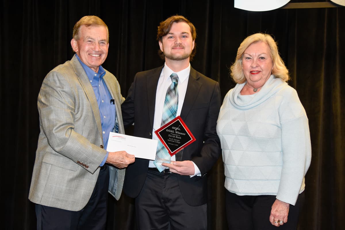 South Georgia Technical College President Emeritus Sparky Reeves (l) and Allene (right) are shown above presenting a scholarship check to 2020 GOAL winner David Bush (c).