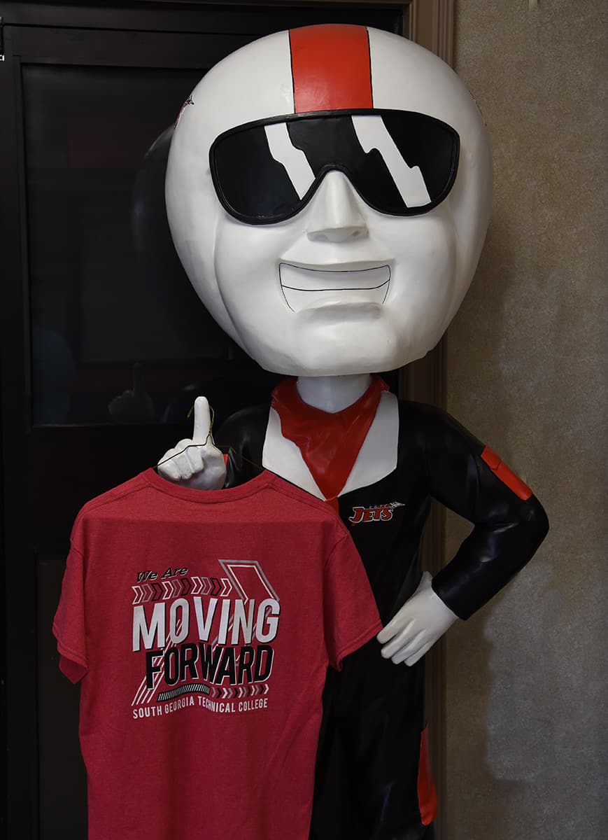 SGTC Bobble Head ACE is showing off the new South Georgia Tech “Moving Forward” t-shirt. South Georgia Tech is hosting Fall Semester registration July 21st, 22nd, and 23rd from 9 a.m. to 4 p.m. Students who sign up for Fall semester classes will receive an SGTC mask and a free t-shirt with the “Moving Forward” slogan while supplies last.