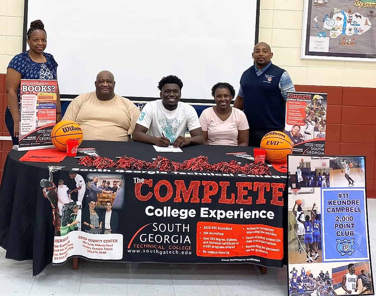 Webster County graduate Keundre Campbell (seated center) has signed a full-scholarship with the South Georgia Technical College Jets for the 2020 – 2021 season. Shown above seated (center) is Keundre Campbell with his father (left) Robert Campbell and his mother, (right) Debbie Merrit. Shown standing left to right are WCHS Assistant Coach Diane Thomas and WCHS Head Coach Keeyon Battle.