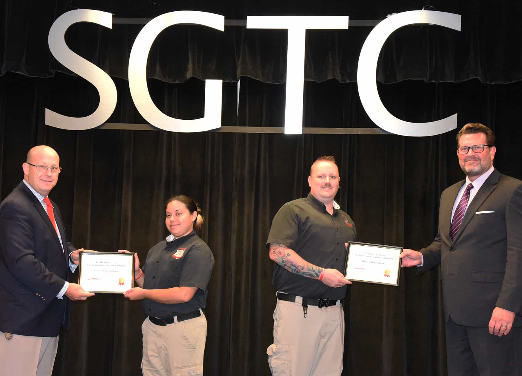 South Georgia Technical College Law Enforcement Academy Director Brett Murray is shown above presenting the Lt. Michael Sangster Law Enforcement Academy Scholarship to Yamilette Martinez-Rodriguez and William McClanahan is shown receiving his scholarship certificate from South Georgia Technical College President Dr. John Watford.
