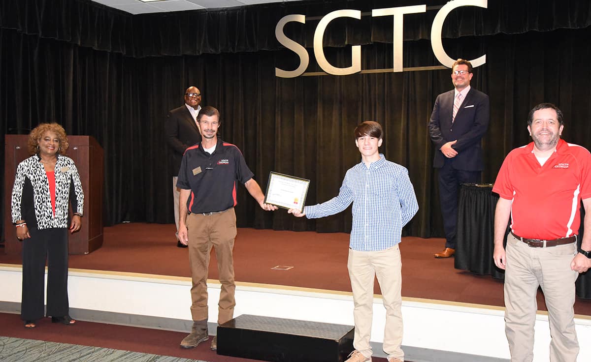 South Georgia Technical College President Dr. John Watford is shown above (back row far right) along with Al Harris (back row left), Vickie Austin (front row l to r), SGTC Automotive Technology Instructor Brandon Dean, Jones-Harris Scholarship recipient Stewart Houston, and Tom Jones. Not shown is SGTC Foundation executive director Su Ann Bird.
