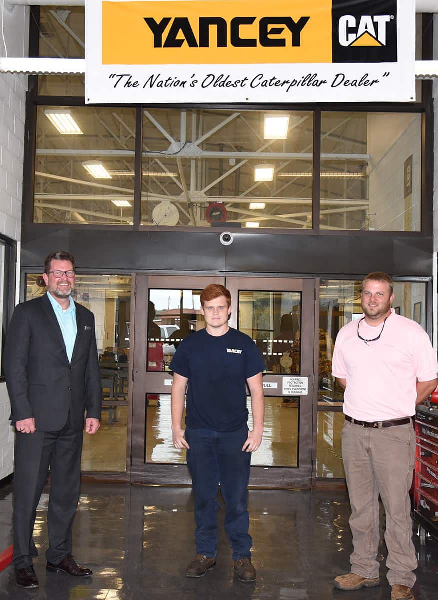 South Georgia Technical College President Dr. John Watford is shown above with Douglas and Hartsfield under the Yancey Caterpillar banner hanging in the SGTC Heavy Equipment Dealer’s Service Technology building on the Americus campus.
