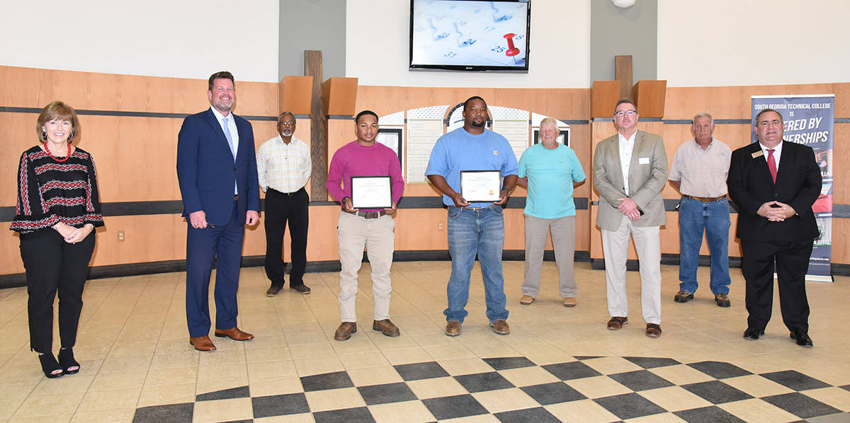 South Georgia Technical College President Dr. John Watford (second from left) is shown above presenting Zykieal Johnson and Marcus Shipp with Georgia Power Electrical Lineworker Scholarship certificates. Also shown (l to r) are SGTC Economic Development Assistant Tami Blount, Dr. Watford, SGTC Lineworker Instructor Sidney Johnson, Scholarship winners Zykieal Johnson and Marcus Shipp, Lineworker instructor Bobby Baxley, Georgia Power Region External Affairs’ Don Porter, Electrical Lineworker Instructor Dewey Turner and SGTC Economic Development Director Paul Farr.