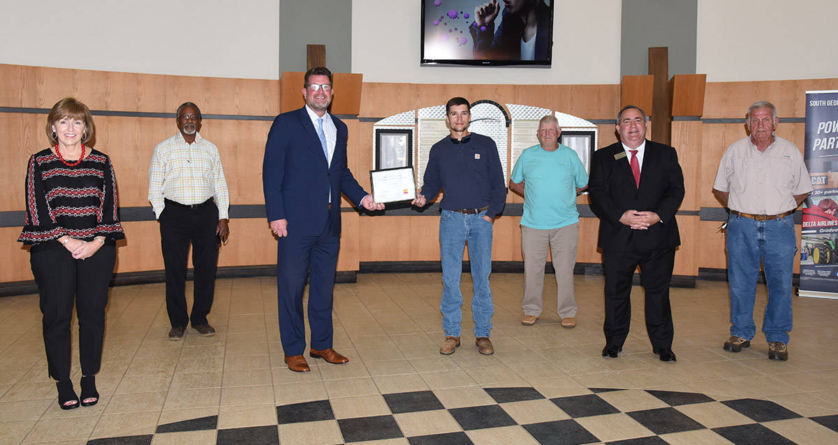 South Georgia Technical College President Dr. John Watford (third from left) is shown above presenting Tyler Beckon with the Kyle Glenn Holcombe Electrical Lineworker Scholarship certificate. Also shown (l to r) are SGTC Economic Development Assistant Tami Blount, SGTC Lineworker Instructor Sidney Johnson, Dr. Watford, Tyler Beckon, Lineworker instructor Bobby Baxley, SGTC Economic Development Director Paul Farr, and Electrical Lineworker instructor Dewey Turner.