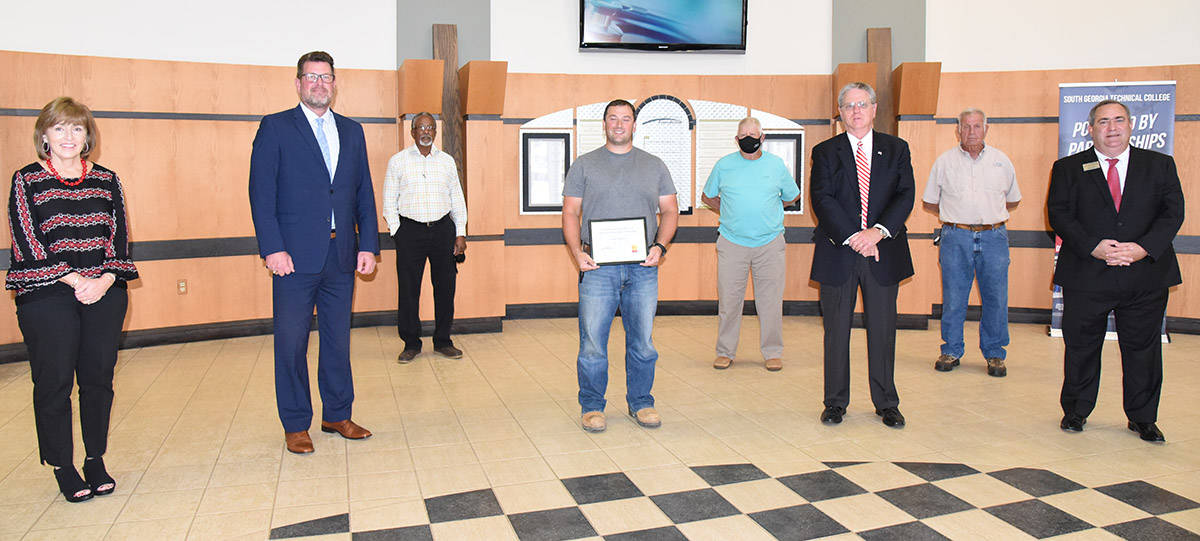 South Georgia Technical College President Dr. John Watford (second from left) is shown above presenting Louis Mahovetz with the Chattahoochee Flint RESA Electrical Lineworker Scholarship certificate. Also shown (l to r) are SGTC Economic Development Assistant Tami Blount, Dr. Watford SGTC Lineworker Instructor Sidney Johnson, Scholarship recipient Louis Mahovetz, Lineworker instructor Bobby Baxley, Chattahoochee Flint RESA Director Richard McCorkle, Electrical Lineworker instructor Dewey Turner and SGTC Economic Development Director Paul Farr.