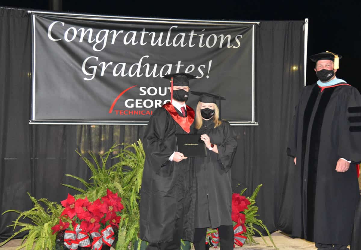 South Georgia Technical College President Dr. John Watford (right) is shown above with Tanner Joseph Rundle who received an associate degree in Criminal Justice and his mom, SGTC Practical Nursing Instructor Christine Rundle, who got to present her son with his degree.