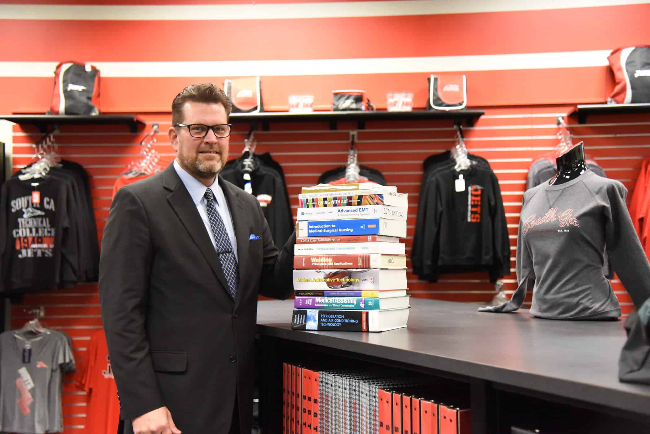 Shown above is South Georgia Technical College President Dr. Watford with a representative stack of college textbooks that are provided for students to use at no cost at SGTC when they enroll for Spring semester. Classes start January 13th. The New Year is a great time to look at expanding or exploring new career options.