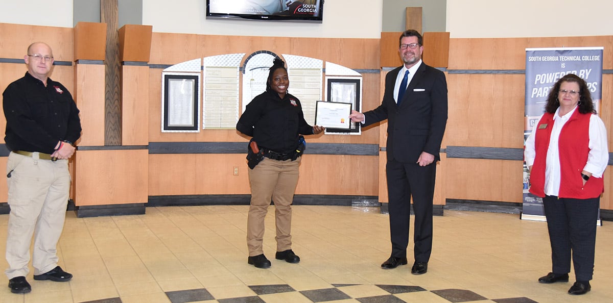 Courtney Seay of the South Georgia Technical College Law Enforcement Academy Class 20-02 is shown above (left center) with her Lou Crouch Law Enforcement Academy Scholarship award. Shown with Seay is SGTC Law Enforcement Academy Director Brett Murray (left), South Georgia Technical College President Dr. John Watford (right center) and SGTC Assistant Vice President of Student Affairs and Law Enforcement Academy instructor Vanessa Wall (right).