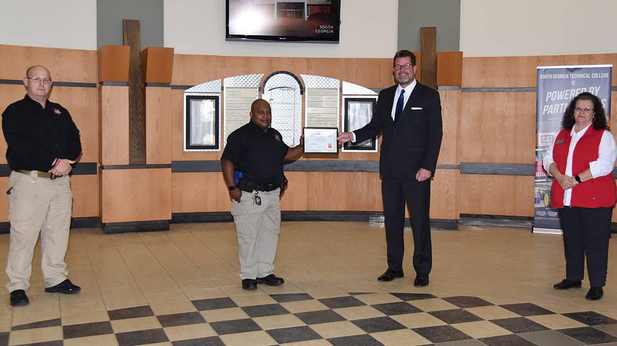 South Georgia Technical College President Dr. John Watford is shown above presenting the Lt. Michael Sangster Law Enforcement Academy Scholarship to Wesley Roshawd Poke of Ashburn, GA. Also shown are Law Enforcement Academy Director Brett Murray (left) and SGTC Assistant Vice President of Student Affairs and Law Enforcement Academy instructor Vanessa Wall (right).