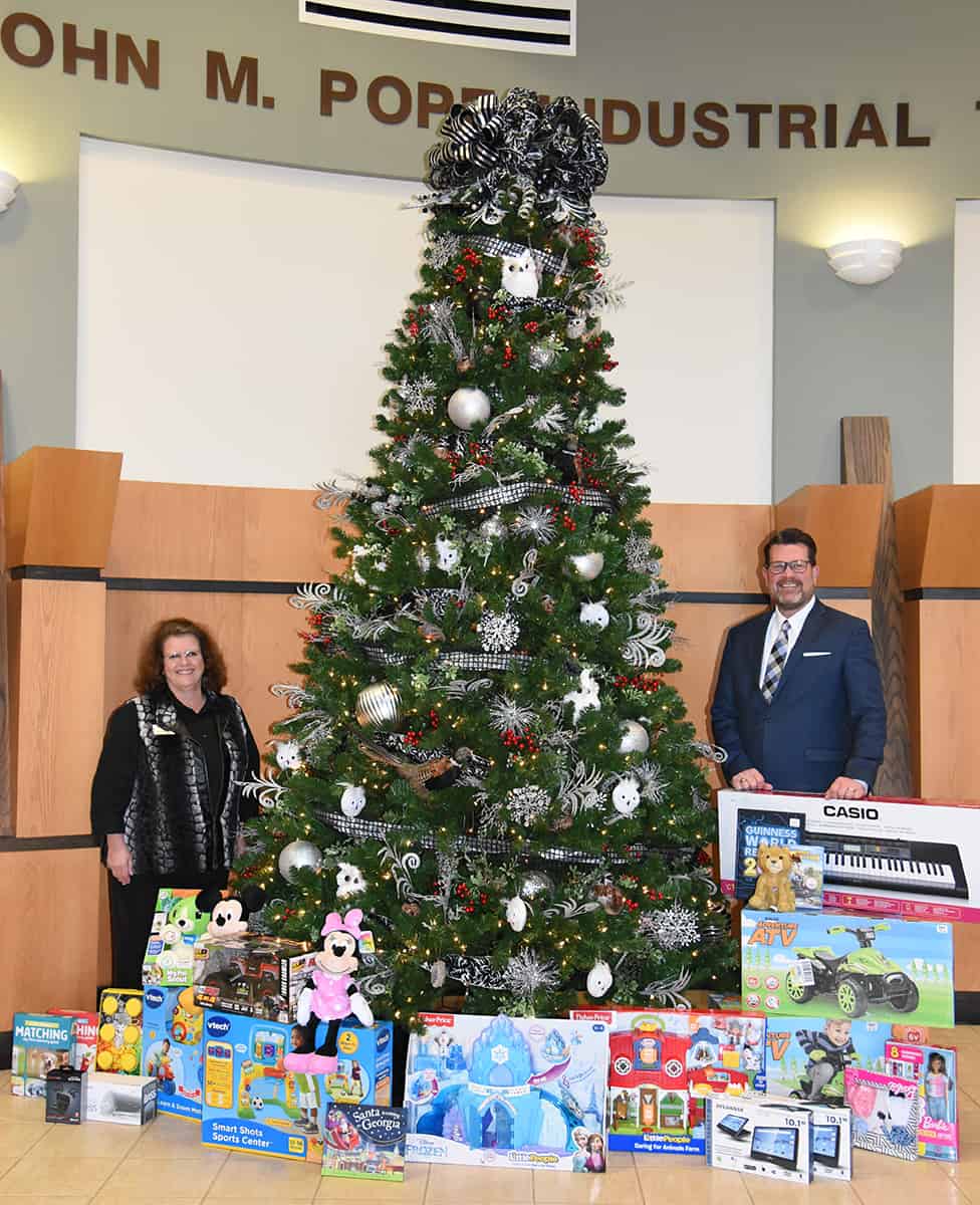 South Georgia Technical College Assistant Vice President of Student Affairs Vanessa Wall is shown above with SGTC President Dr. John Watford in front of the SGTC Christmas Tree surrounded by toys for the Governor’s Secret Santa program.