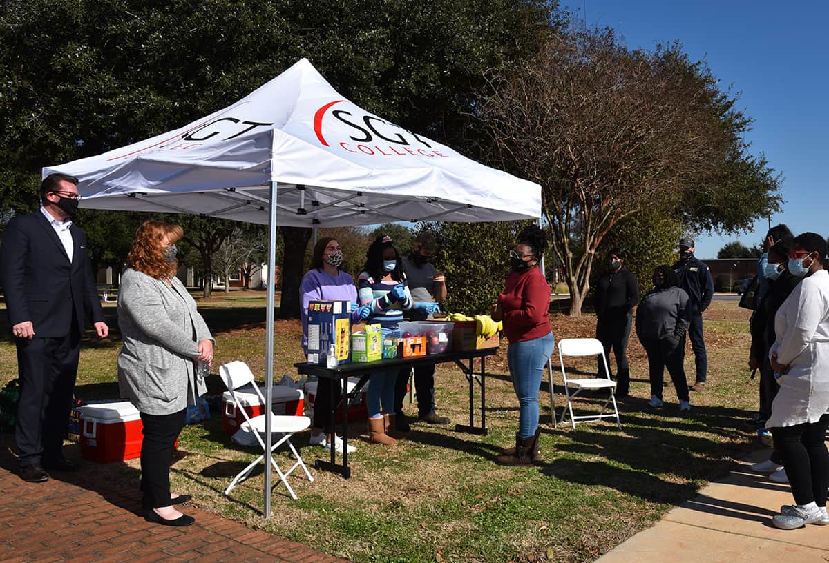 SGTC President Dr. John Watford (left) is shown above talking with some of the students and instructors who dropped by the SGTC Student Government Association tent for some delicious snacks during the “Welcome to Spring Semester” event.