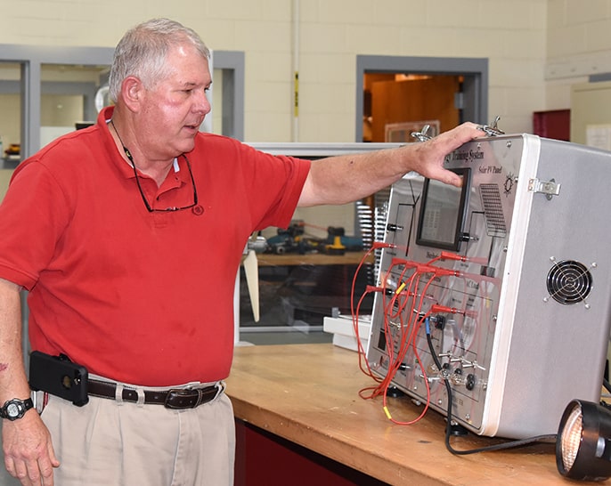 South Georgia Technical College Crisp County Center Electrical Systems Technology Instructor Mike Enfinger is shown above with one of the small trainers that he uses to help students learn about the Electrical Technology field.
