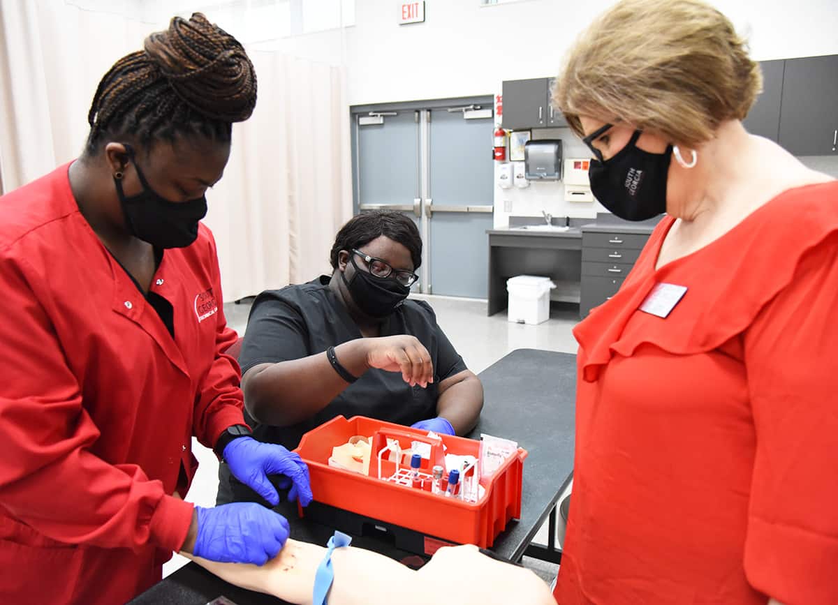South Georgia Technical College Crisp County Center Medical Assisting Instructor Carol Cowan (right) is shown above with two students learning to draw blood.